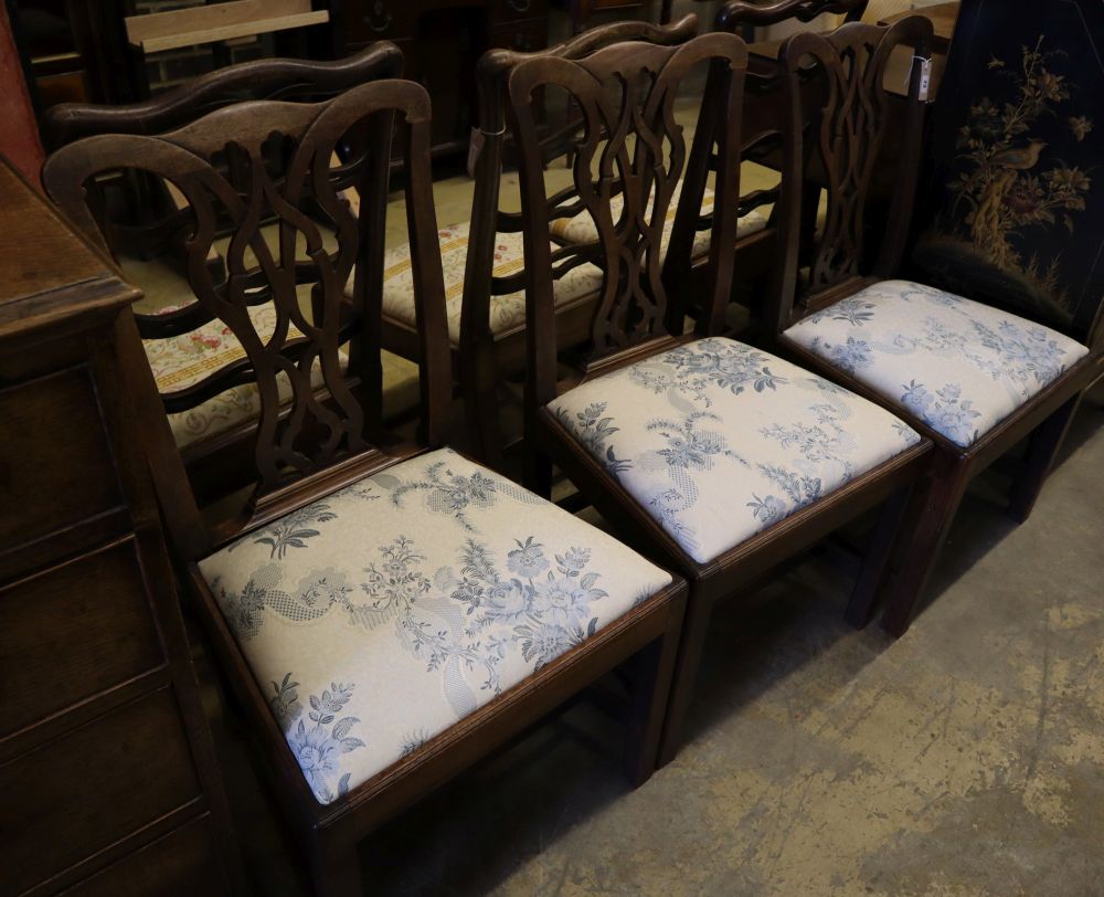 A set of three George III mahogany dining chairs with crewel-work seats and another set of three George III dining chairs (6)